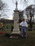 stands beside the restored grave marker for Jim Creighton, baseball's first superstar, at Green-Wood Cemetery in Brooklyn.